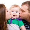 Mom And Dad Kissing Baby